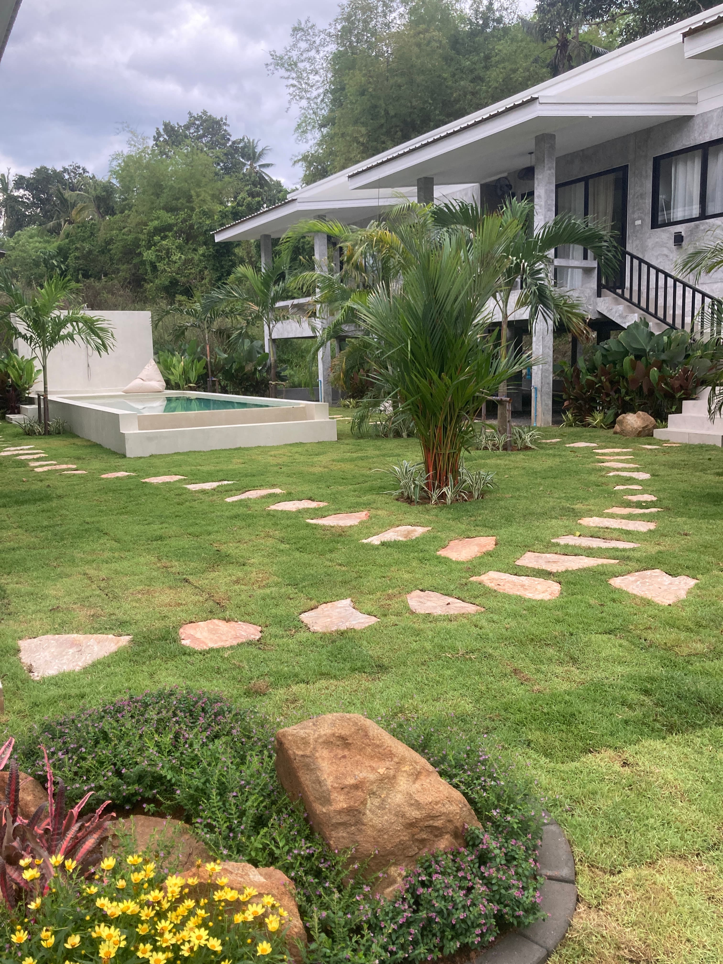 Garden with stepping stone path leading to the pool